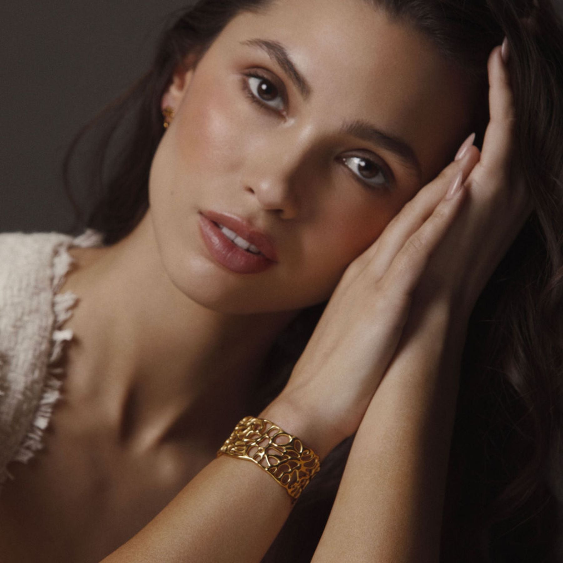 Model wearing Abstract cuff bracelet in 18k yellow gold.