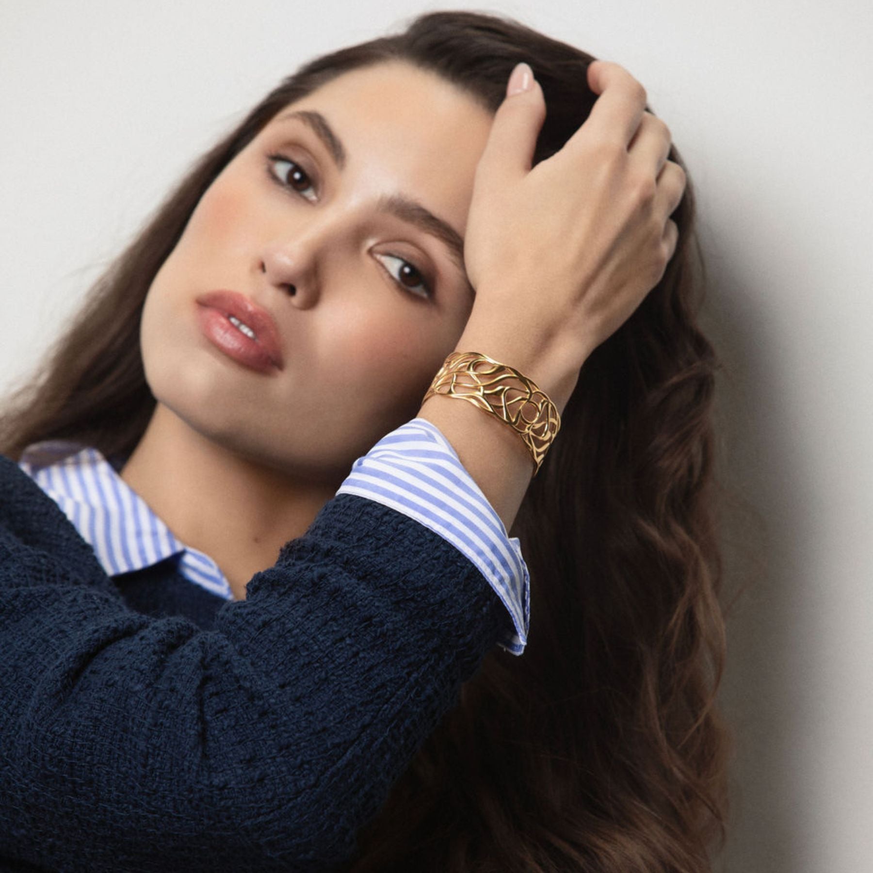 Model wearing Elegantly fluid cuff bracelet in 18k gold vermeil.