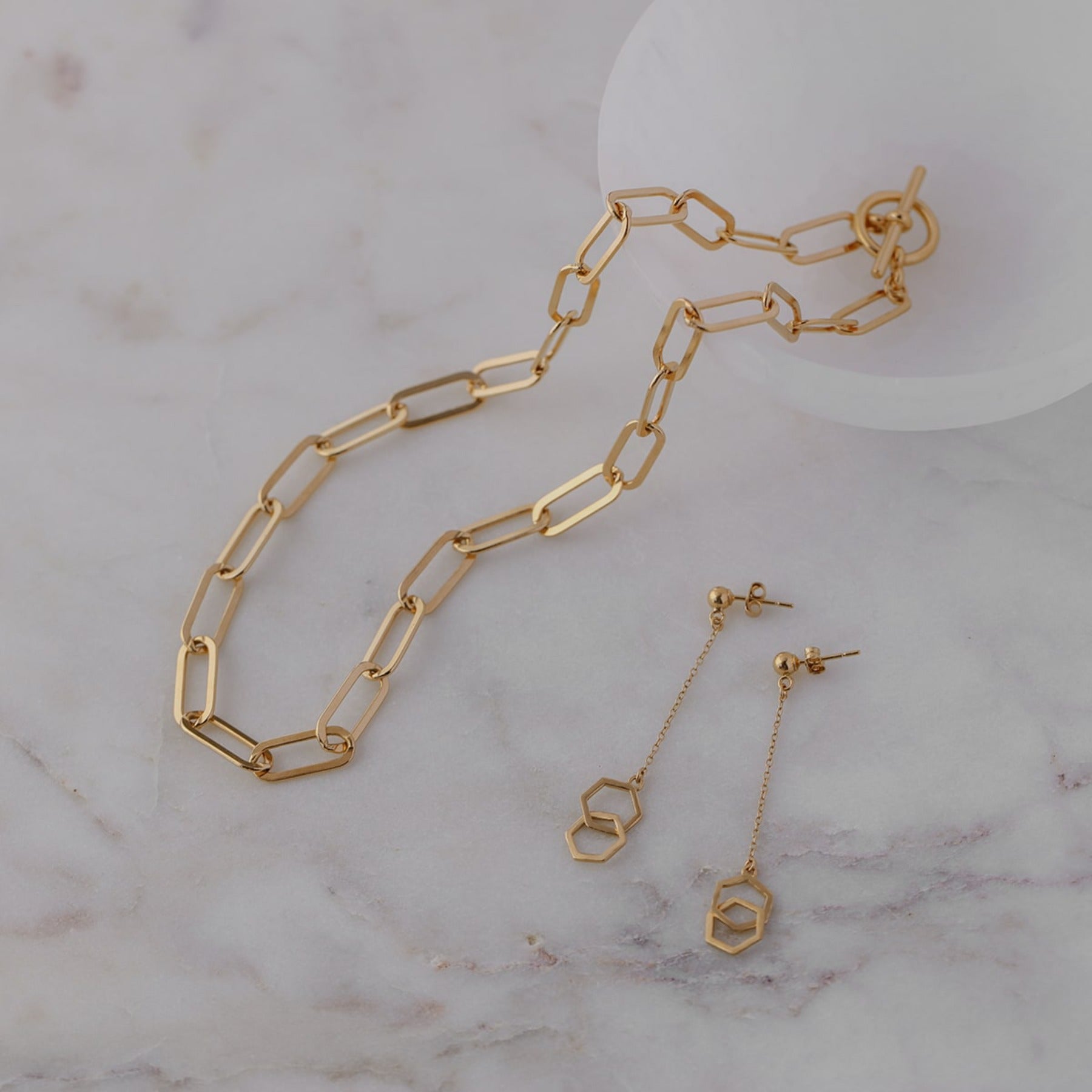 Geometric drop earrings with tiny interlocking hexagons on a delicate chain in 18k gold vermeil.