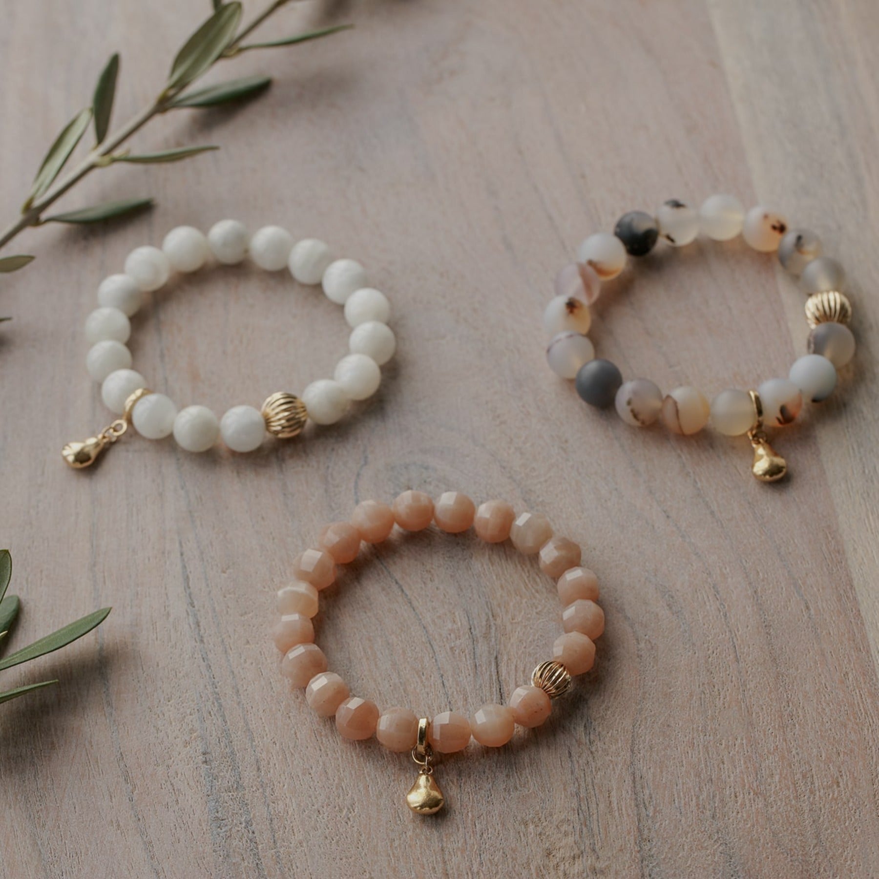 Montana agate crystal smooth gemstone elastic bracelet with 14k gold corrugated bead and pear charm.