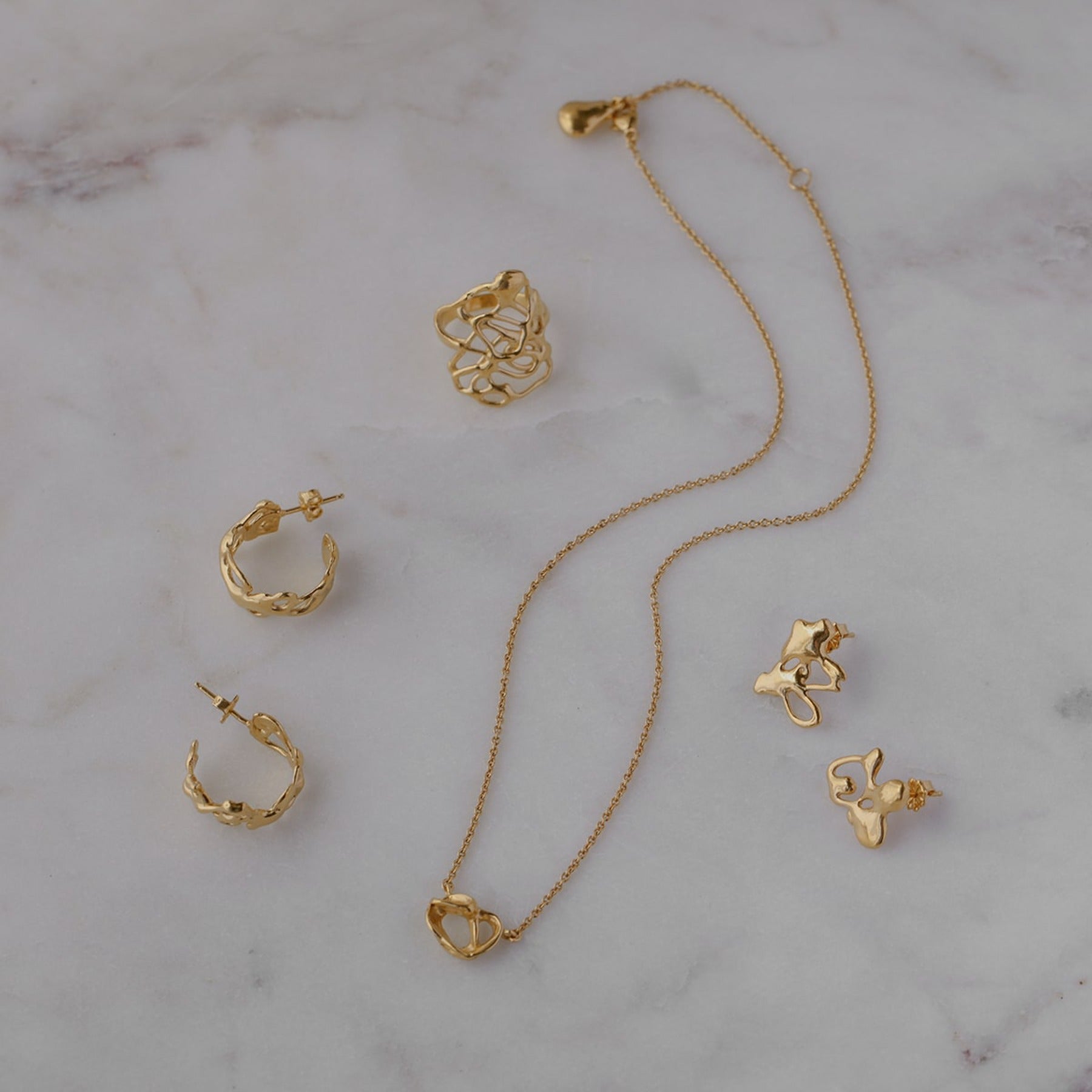 Abstract, squiggle puzzle piece stud earrings in 18k gold vermeil.