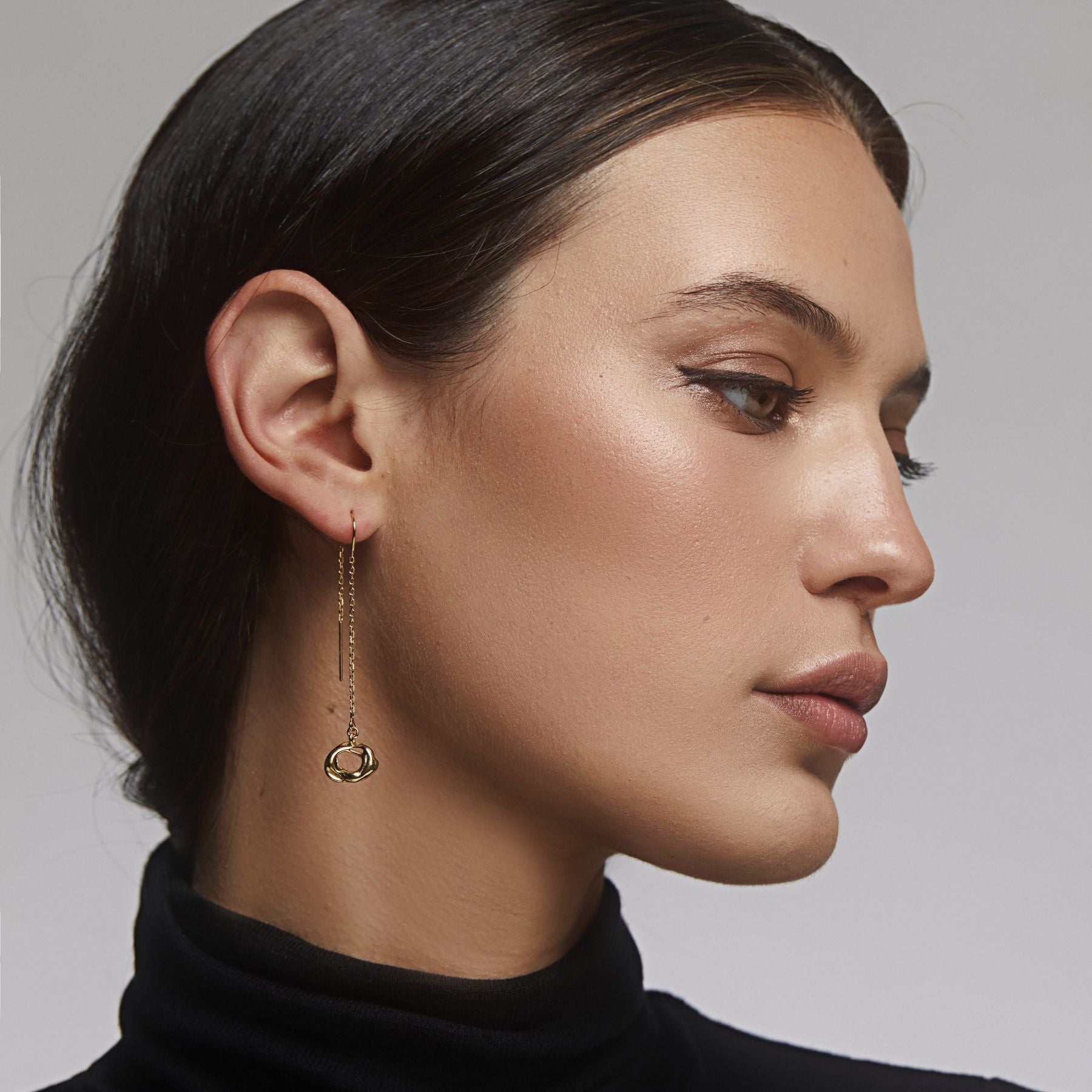 Abstract, circle dangling from a threader earring chain in 18k gold vermeil.
