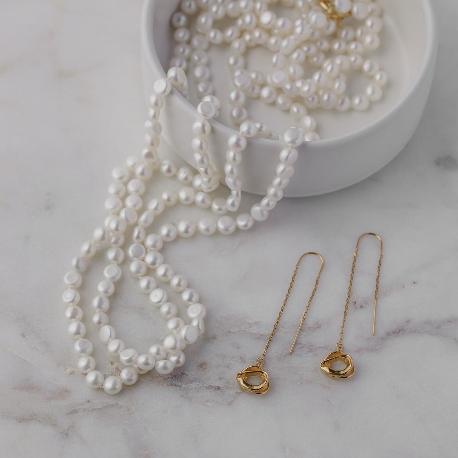 Long opera length button pearl necklace with 14k gold filled toggle clasp.