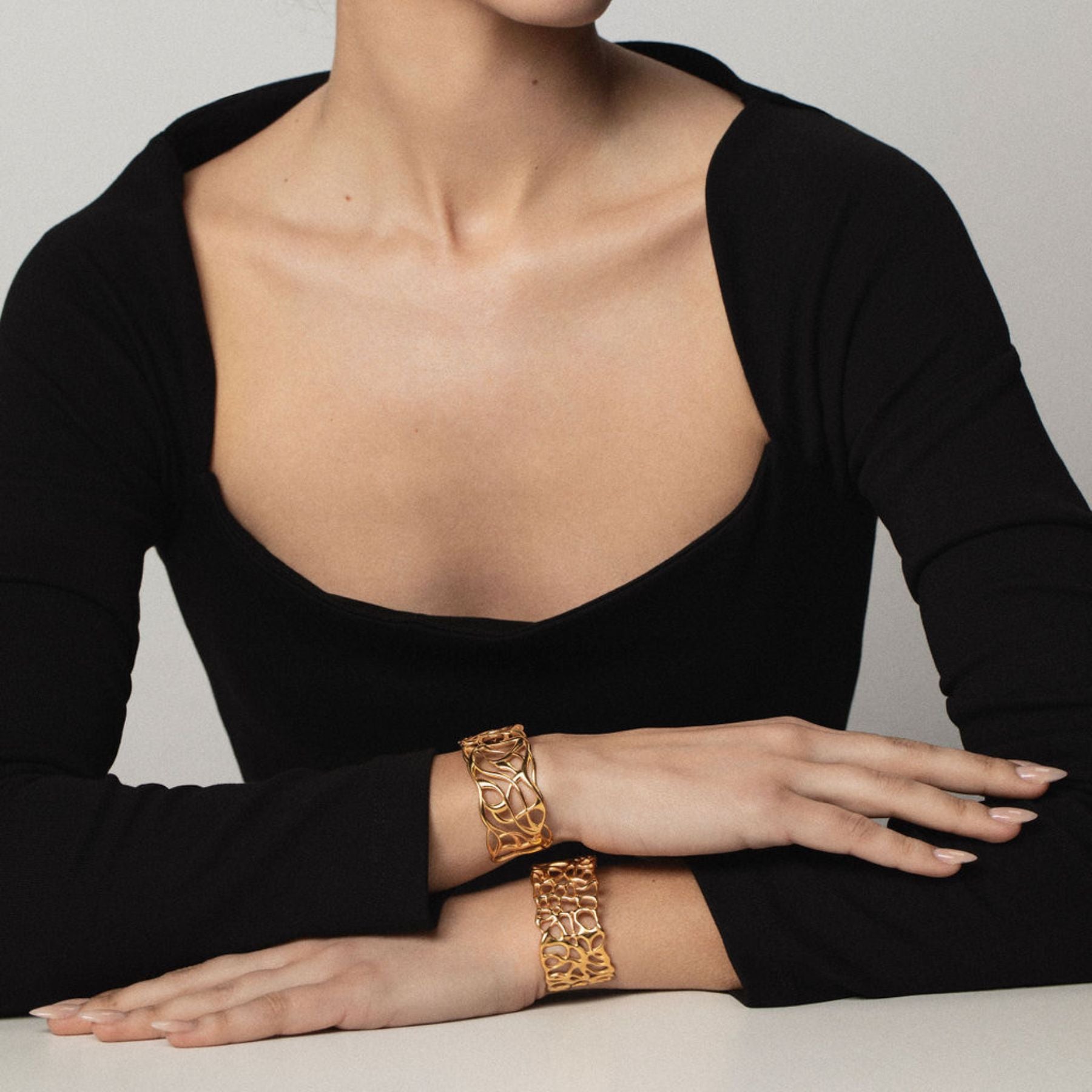 Model wearing Abstract cuff bracelets in 18k yellow gold.