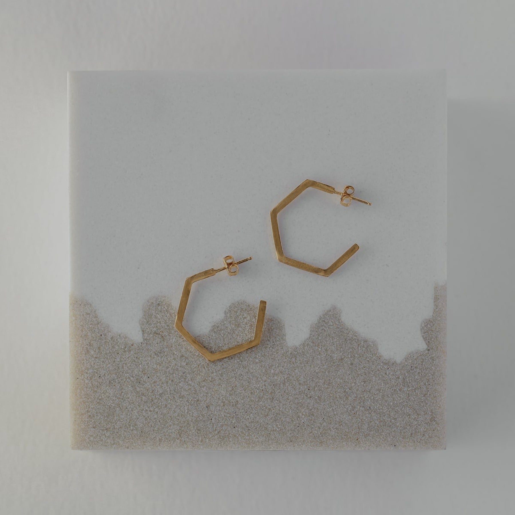 Distressed geometric small hexagon hoop earrings in 18k gold vermeil.