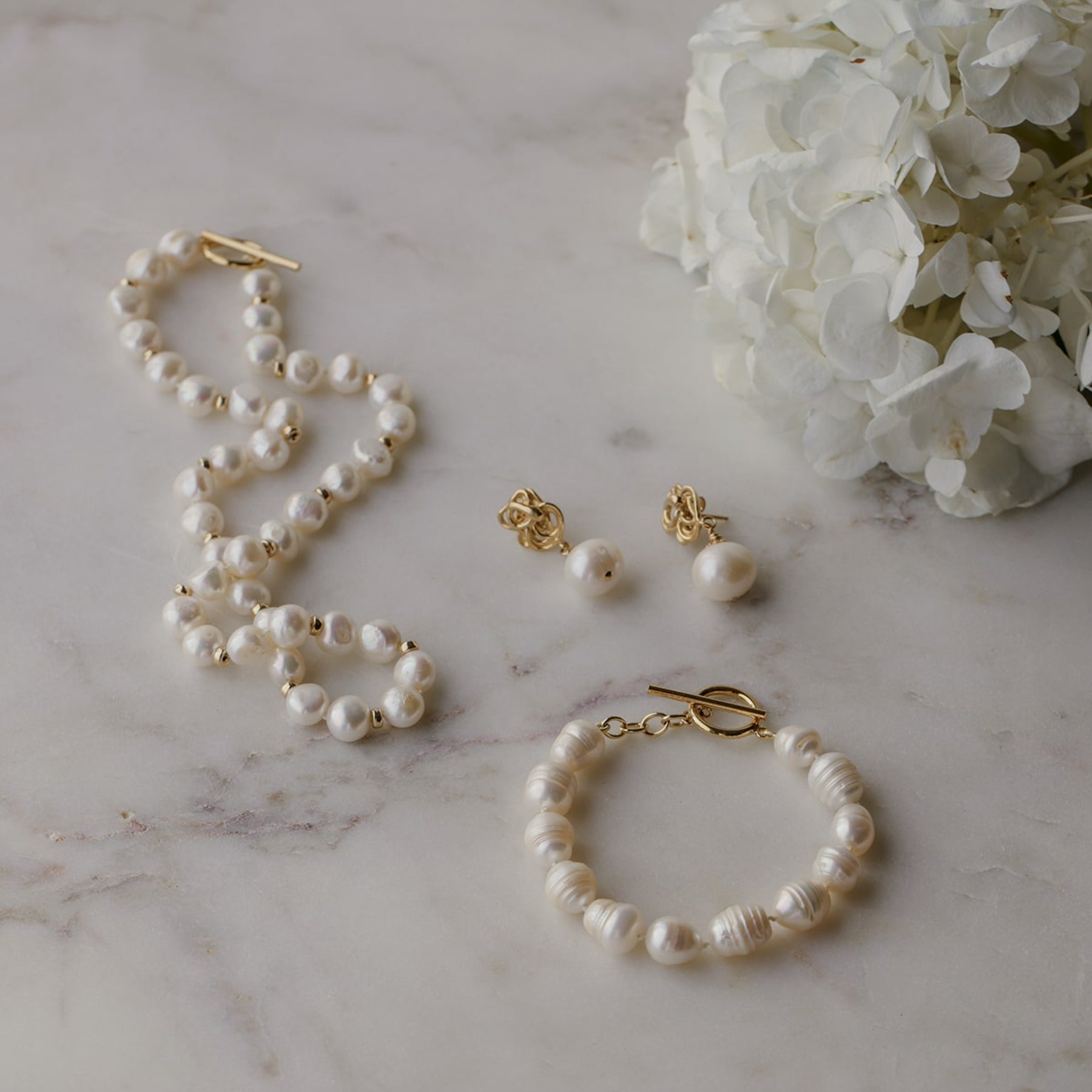 Freshwater cultured button pearl necklace with 14k gold-filled beads interspersed and finished with a 14k gold-filled toggle clasp.