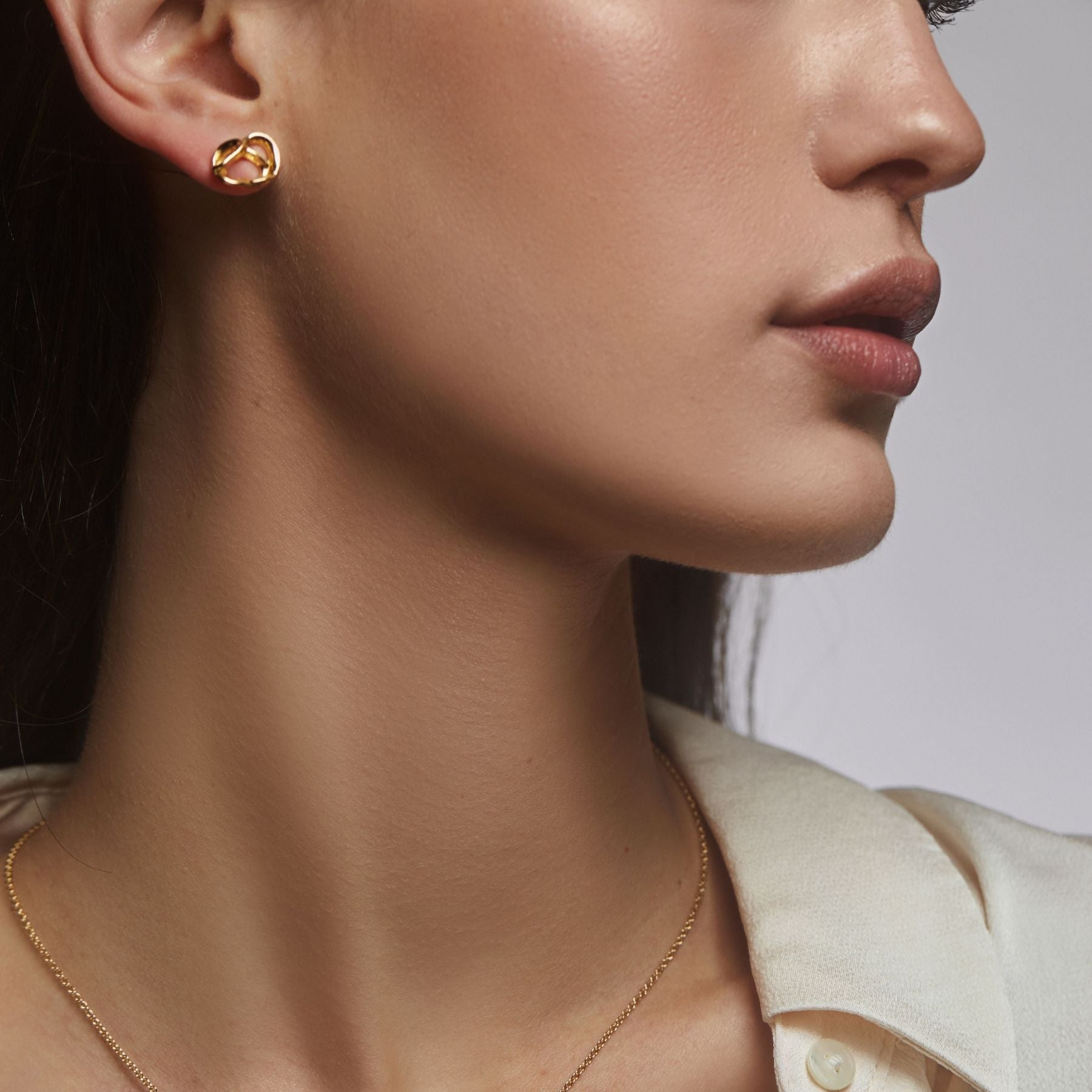 Abstract pretzel stud earrings in 18k gold vermeil.